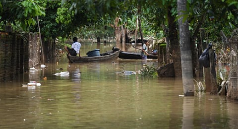 FILE - A man sits on the his wooden boat on a flooded street in Bilin township, in Myanmar's Mon state, on August 11, 2023. (Photo | AFP)