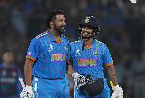 India's captain Rohit Sharma celebrates his century with teammate Ishan Kishan during the World Cup match against Afghanistan in New Delhi (Photo | AP)