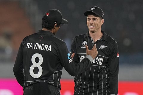 Mitch Santner winks at his teammate Rachin Ravindra after finishing his bowling spell during the World Cup match against Netherlands (Photo | AP)