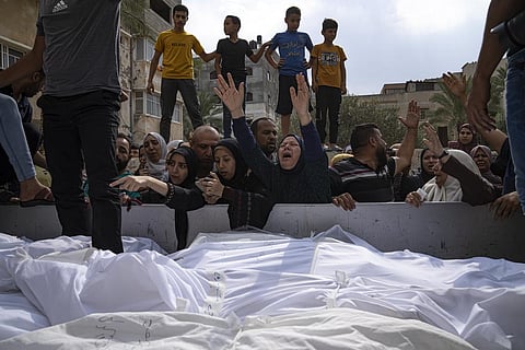Relatives mourn people killed in an Israeli air strike in Gaza City on Monday, Oct. 9, 2023. (Photo | AP)