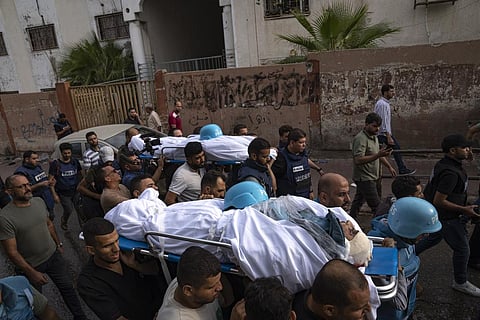 Palestinians, including some journalists, carry the bodies of two Palestinian reporters, Mohammed Soboh and Said al-Tawil, who were killed by an Israeli airstrike in Gaza City, on Oct. 10, 2023. (AP)