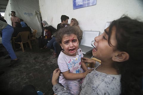 Palestinian children wounded in Israeli strikes cry outside a hospital in Rafah refugee camp, southern Gaza Strip, Thursday, Oct. 12, 2023. (Photo | AP)