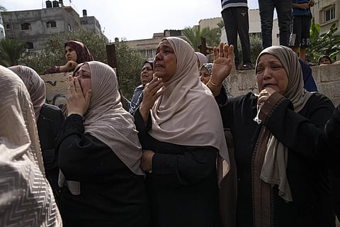 Relatives mourn people killed in an Israeli air strike in Gaza City on Monday, Oct 9, 2023. (Photo | AP)