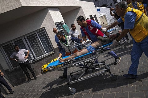 A person injured in Israeli bombing is brought to a hospital in Gaza City, Oct 11, 2023. (Photo | AP)