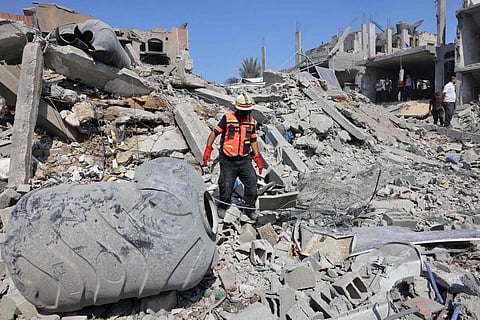 Palestinian rescuers search the rubble of destroyed buildings following an Israeli strike, as battles between Israel and Hamas militants continue in the city of Rafah. (P