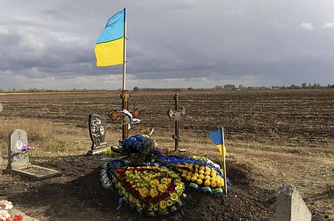 The grave of Ukrainian soldier Andrii Kozyr, who was reburied the day before, in the village of Hroza near Kharkiv, Ukraine, Friday, Oct. 6, 2023. (Photo | AP)