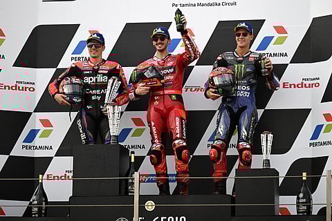Ducati's Francesco Bagnaia (C), Aprilia’s Maverick Vinales (L), and Yamaha's Fabio Quartararo celebrate during the podium ceremony in the Indonesian GP, Oct 15, 2023. (Photo | AFP)