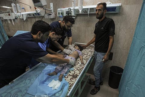 A Palestinian child wounded during an Israeli airstrike receives medical treatment at al-Aqsa hospital in Deir el-Balah, central Gaza Strip, Sunday, Oct. 15, 2023. (Photo | AP)