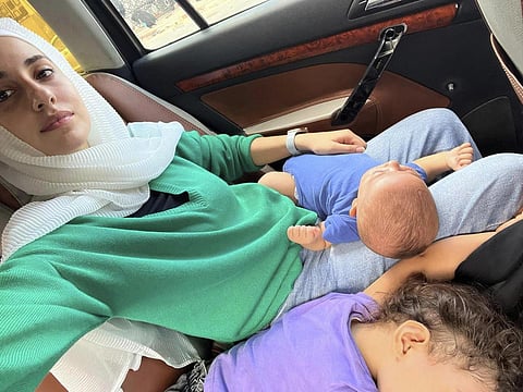 Haneen Okal, a Palestinian American, heads towards the Rafah crossing in Egypt for the second time with her three young children, as they try to leave Gaza, Oct 14, 2023. (Photo | AP)