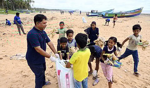 Fr Peter Darvin of St Thomas Church at Poonthura leading a clean-up drive on the Poonthura beach on Saturday along with children and youths | Vincent Pulickal