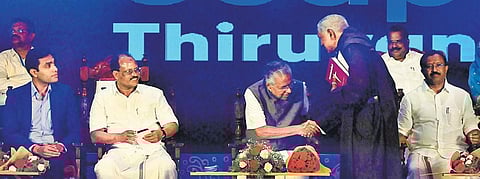 An unidentified Capuchin priest, not in the list of invitees, enters the dais and shakes hand with Chief Minister Pinarayi Vijayan at the function to welcome its first ship that reached the Vizhinjam