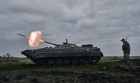 A Ukrainian APC fires towards Russian positions near Avdiivka in the Donetsk region of Ukraine (Photo | AP)