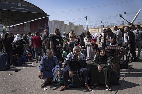 Palestinians wait to cross into Egypt at the Rafah border crossing in the Gaza Strip on Monday, Oct.16, 2023. (Photo | AP)