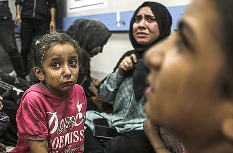 Wounded Palestinians sit in al-Shifa hospital in Gaza City. (Photo | AP)