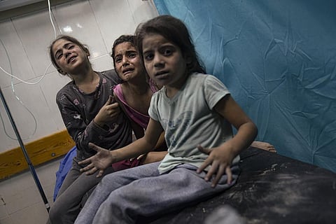 Palestinian children wounded in the Israeli bombardment of the Gaza Strip wait for treatment in a hospital in Khan Younis, Tuesday, Oct. 17, 2023. (Photo | AP)