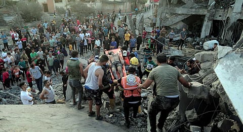Palestinians evacuates a survivor from a destroyed house hit by an Israeli airstrike in town of Khan Younis, southern Gaza Strip, Tuesday, Oct. 17, 2023. (AP/PTI)