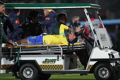 Brazil's Neymar is carried off the pitch on a stretcher after being injured in the FIFA World Cup qualifying match against Uruguay. (Photo | AP)