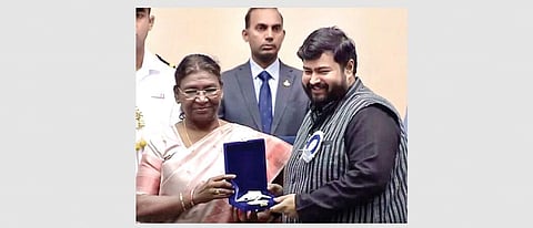 Director Anupam Patnaik receiving the award from the President | Express