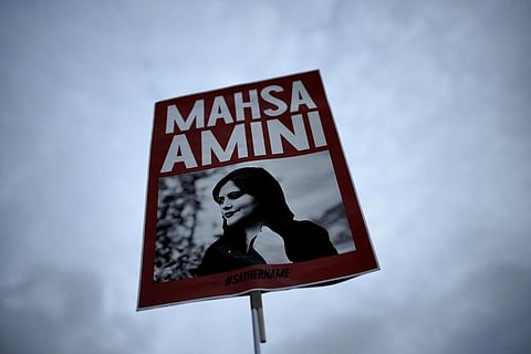 FILE - A woman holds a placard with a picture of Iranian woman Mahsa Amini during a protest against her death, in Berlin, Germany, Wednesday, Sept. 28, 2022. (Photo | AP)