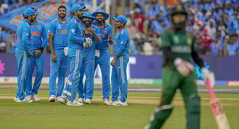 India's team members celebrates the dismissal of Bangladesh's Mushfiqur Rahim, right, during the ICC Men's Cricket World Cup match.(Photo | AP)