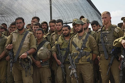 Israeli soldiers listen to Israel's Defense Minister Yoav Gallant, during his visit to a staging area near the border with the Gaza Strip in southern Israel (Photo | AP)