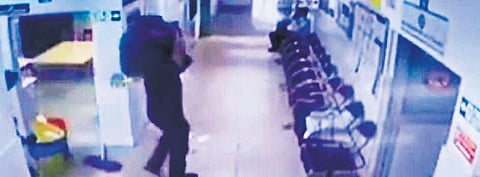 CCTV grab of a thief taking away the lab equipment in Capital Hospital
