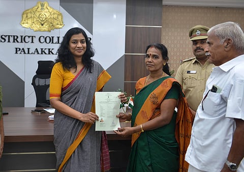 Palakkad District Collector S Chithra handing over the certificate of Indian citizenship to U Radha at the collectorate on Wednesday
