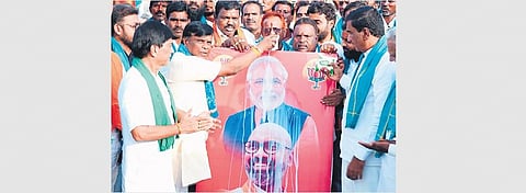 BJP leaders perform ‘paalaabhishekam‘ to PM Modi at Agriculture Market Yard in Nizamabad on Sunday over the announcement of National Turmeric Board.