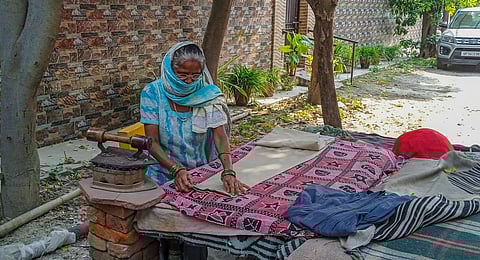 Mother of a Nithari killing case victim irons at a colony, in Noida.(Photo | PTI)
