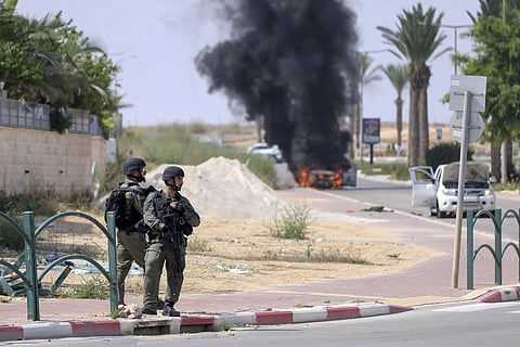 Israeli soldiers take position at the southern Israeli town of Ofakim on Sunday, Oct 8, 2023. (AP)