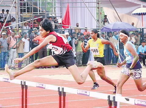 Adhithya Aji of Navamukunda HSS Thirunavaya, Malappuram, won gold in the junior girls’ 100 metre hurdles at the state school sports meet in Kunnamkulam, Thrissur, on Thursday | S lal