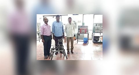 Researchers with the engine developed at Govt Engineering College, Barton Hill, Thiruvananthapuram