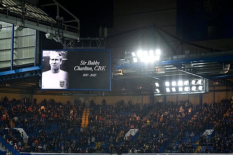 A photograph of Sir Bobby Charlton is displayed on a big screen in the half-time break as news of his passing spreads, during the EPL football match between Chelsea and Arsenal. (Photo | AFP)