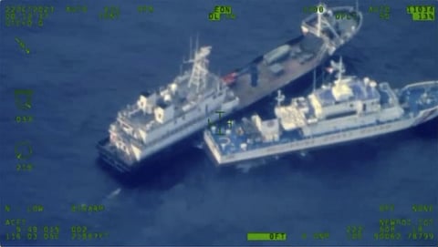 This image released by the Armed Forces of the Philippines, shows a Chinese militia vessel, top, and Philippine coast guard vessel BRP Cabra as they approach Second Thomas Shoal. (Photo | AP)