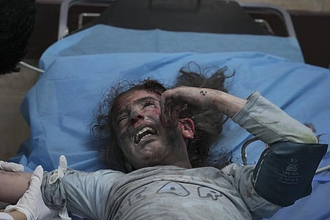 A Palestinian girl, wounded in an Israeli bombardment on the Gaza Strip, cries in a hospital in Dier al -Balah, south of Gaza Strip, Oct 21, 2023. (Photo | AP)