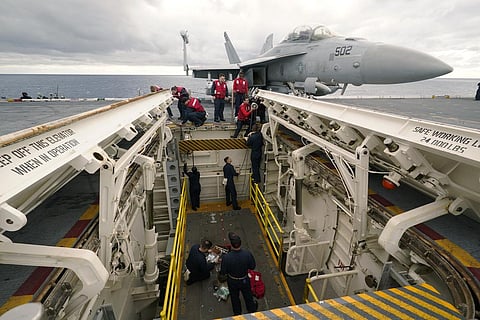 Weapons personnel work on a weapons elevator on the flight deck of the aircraft carrier USS Gerald R. Ford. (Photo | AP)