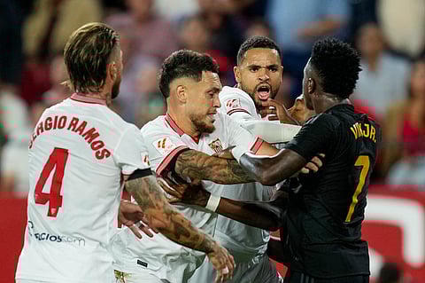 Real Madrid's Vinicius Junior argues with Sevilla players during a Spanish La Liga football match between Sevilla and Real Madrid. (Photo | AP)
