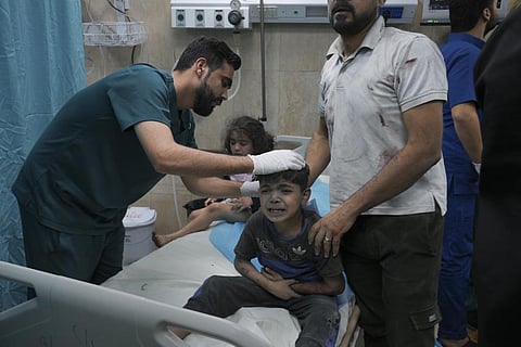 A Palestinian boy, wounded in Israeli bombardment on Gaza Strip, cries in a hospital in Deir al-Balah, south of the Gaza Strip, Saturday, Oct. 21, 2023. (AP)