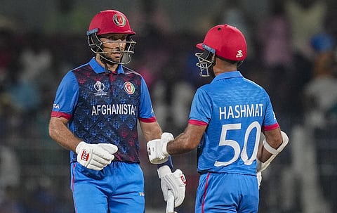 Afghanistan's Rahmat Shah congratulated by Hashmatullah Shahidi after he completed his half century during the World Cup 2023 match at MA Chidambaram Stadiumin, Chennai, Oct 23, 2023. (Photo | PTI)