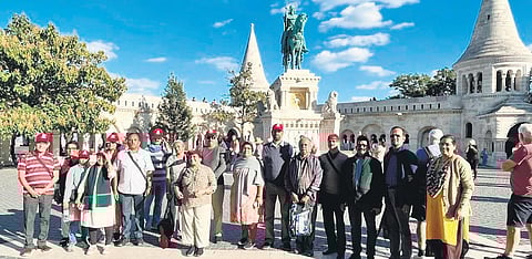 A group of senior citizens from Kerala at the statue of King Stephen in the Hungarian capital of Budapest