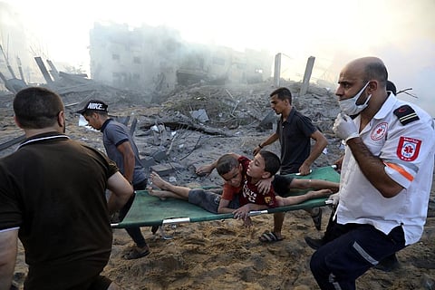 Palestinians evacuate two wounded boys following Israeli airstrikes on Gaza City, Wednesday, Oct. 25, 2023. (Photo | AP)