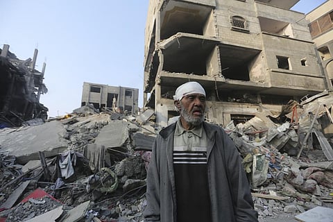 A Palestinian stands outside the building destroyed i the Israeli bombardment of the Gaza Strip in Rafah, Wednesday, Oct 25, 2023. (Photo | AP)