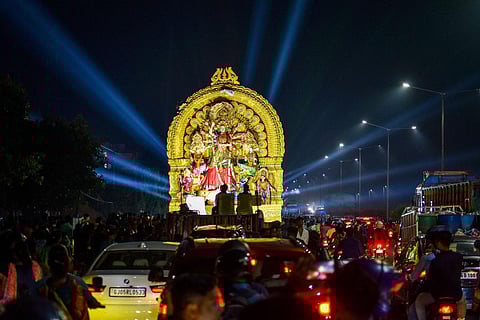 An idol being taken in a procession for immersion at Saheed Nagar in Bhubaneswar. (Photo | Debadatta Mallick)