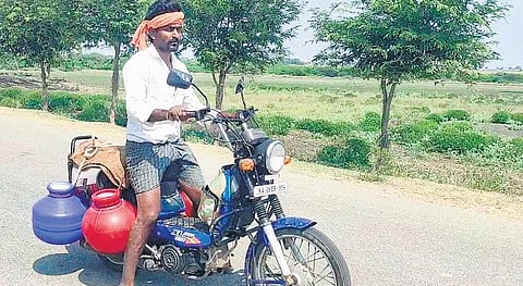 Devappa Korlagundi carries water pots on his motorcycle to his farm at Yarehanchini village in Koppal district | EXPRESS