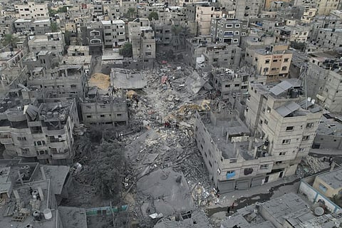 Palestinians inspect the rubble of a house after it was struck by an Israeli airstrike in Khan Younis refugee camp, Gaza Strip, Friday, Oct.27, 2023. (Photo | AP)