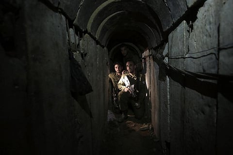 Israeli soldiers walk through a tunnel discovered near the Israel-Gaza border Sunday, Oct. 13, 2013. (Photo | AP)