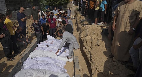 Palestinians bury the bodies of their relatives, killed in the Israeli bombardment of the Gaza Strip. (Photo | AP)
