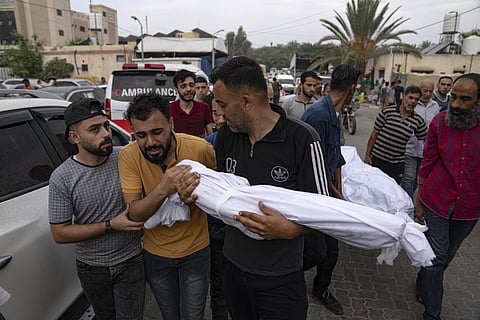 Palestinian mourners carry the body of their relatives killed in the Israeli bombardment of the Gaza Strip, in Khan Younis, Sunday, Oct. 29, 2023. (Photo | AP)