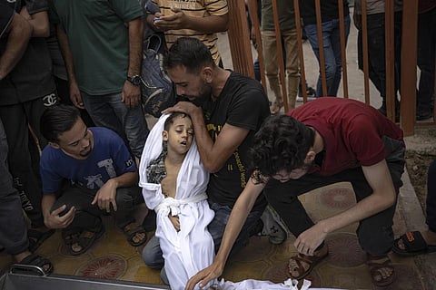 Palestinians mourn their relatives killed in the Israeli bombardment of the Gaza Strip, in a morgue in Khan Younis, Sunday, Oct 29, 2023. (Photo | AP)