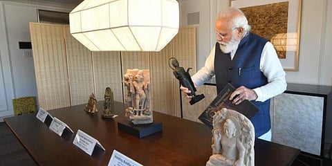 FILE - In this image dated November 2021, PM Narendra Modi with the artefacts and antiquities he brought back to India from New York. (Photo| Twitter)